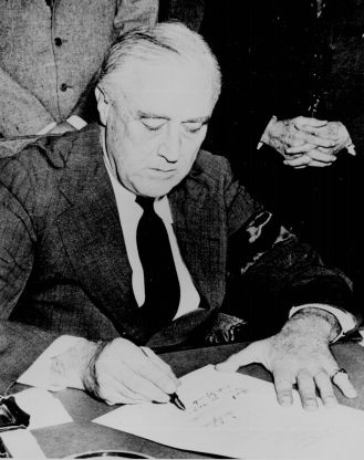 President Franklin D. Roosevelt signs the war declaration